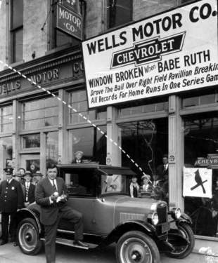 Babe Ruth posing with Car in front of Wells Motor Co.